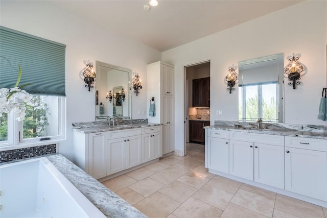 1300 Apache Tears, Horseshoe Bay, TX 78657 - full bath with backsplash, two vanities, a jetted tub, and tile patterned flooring