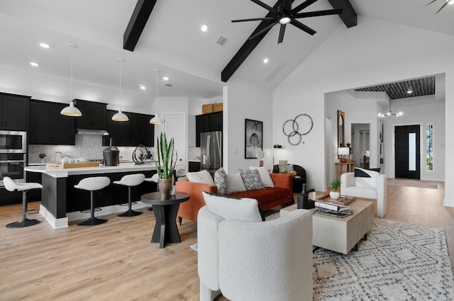 20502 Ed Townes Ter, Manor, TX 78653 - living room featuring beamed ceiling, light wood-style floors, a ceiling fan, high vaulted ceiling, and recessed lighting