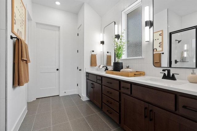 20502 Ed Townes Ter, Manor, TX 78653 - full bathroom with double vanity, baseboards, a stall shower, tile patterned flooring, and recessed lighting