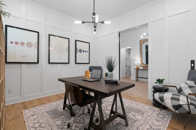 20502 Ed Townes Ter, Manor, TX 78653 - office area with a decorative wall, a chandelier, and light wood-style flooring