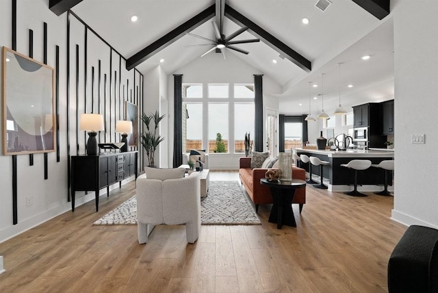 20502 Ed Townes Ter, Manor, TX 78653 - living room with beam ceiling, light wood-style floors, a ceiling fan, high vaulted ceiling, and baseboards