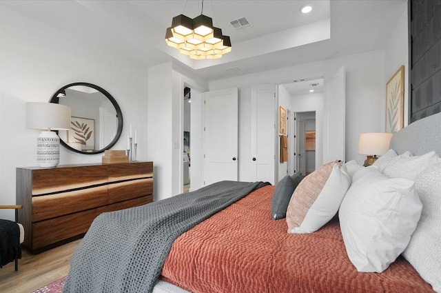 13611 Thomas Wheeler Way, Manor, TX 78653 - bedroom with light wood-style floors, a chandelier, and recessed lighting