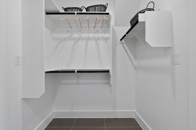 13611 Thomas Wheeler Way, Manor, TX 78653 - spacious closet featuring dark tile patterned flooring