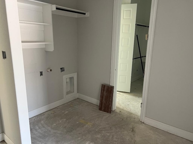 clothes washing area featuring baseboards