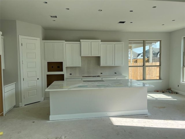 kitchen with a center island and white cabinetry