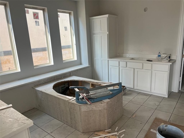 full bathroom featuring tile patterned floors and a bath
