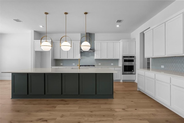 5513 Olimpico Way, Leander, TX 78641 - kitchen featuring stainless steel double oven, wall chimney range hood, white cabinets, recessed lighting, and decorative backsplash