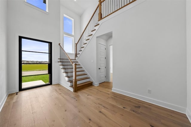 5513 Olimpico Way, Leander, TX 78641 - entryway with a towering ceiling, hardwood / wood-style flooring, and stairway
