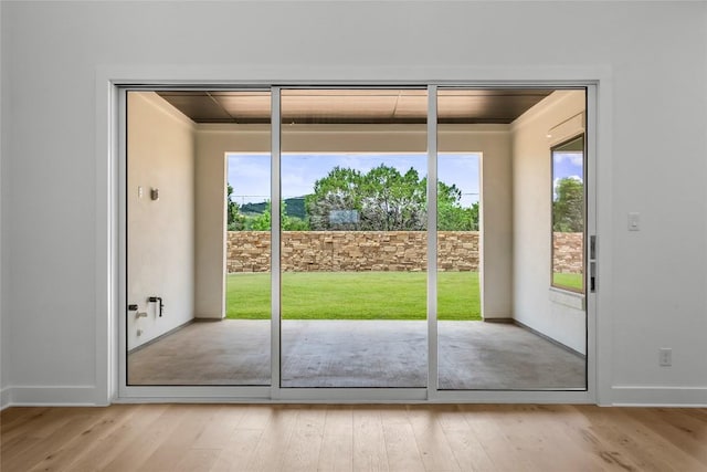 5513 Olimpico Way, Leander, TX 78641 - doorway to outside with light wood-style flooring and ornamental molding