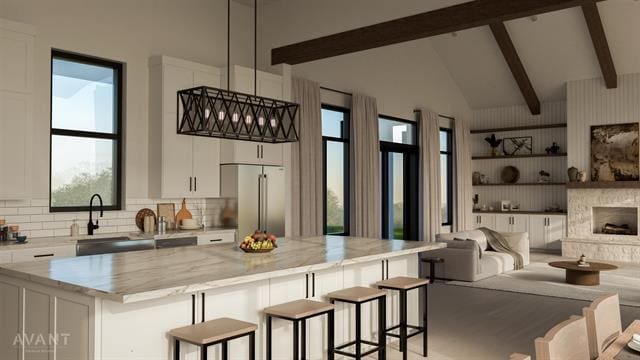 400 Shale, Horseshoe Bay, TX 78657 - kitchen with white cabinetry, a kitchen bar, beam ceiling, high vaulted ceiling, and high quality fridge