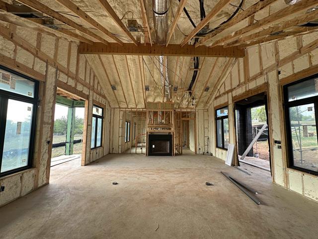 400 Shale, Horseshoe Bay, TX 78657 - unfurnished living room featuring high vaulted ceiling and plenty of natural light