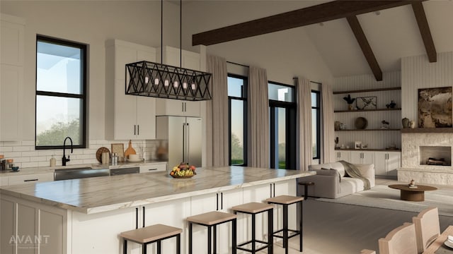 400 Shale, Horseshoe Bay, TX 78657 - kitchen with high end fridge, beamed ceiling, white cabinets, a kitchen bar, and tasteful backsplash