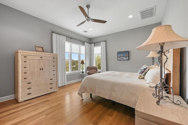 bedroom with visible vents, baseboards, light wood finished floors, and recessed lighting