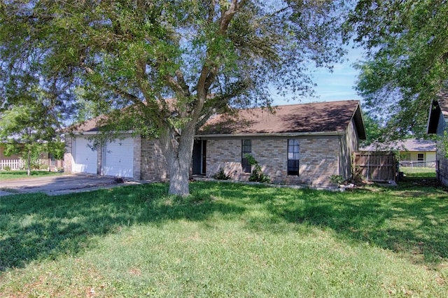 311 August St, Schulenburg, TX 78956 - single story home featuring aphalt driveway, fence, a front lawn, brick siding, and a garage