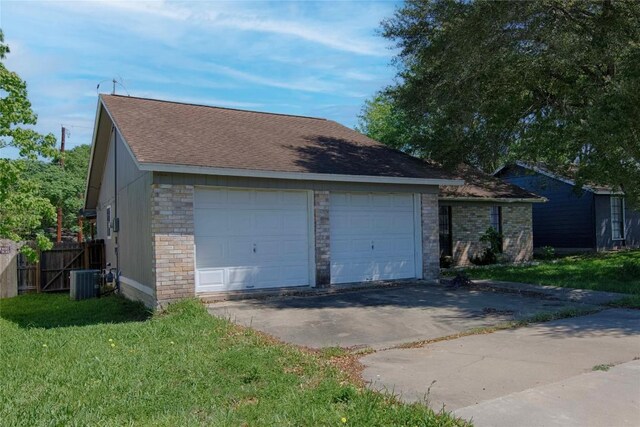 311 August St, Schulenburg, TX 78956 - detached garage featuring fence and central air condition unit