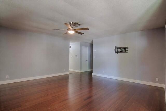 311 August St, Schulenburg, TX 78956 - empty room featuring a textured ceiling, a ceiling fan, baseboards, and dark wood finished floors