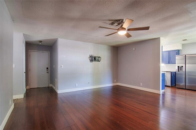 311 August St, Schulenburg, TX 78956 - unfurnished living room with ceiling fan, baseboards, and dark wood-style floors