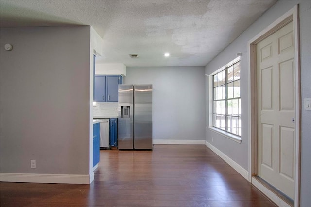 311 August St, Schulenburg, TX 78956 - interior space with dark wood-type flooring, visible vents, baseboards, and a textured ceiling