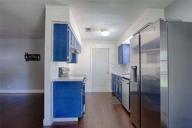 311 August St, Schulenburg, TX 78956 - kitchen featuring blue cabinets, appliances with stainless steel finishes, and dark wood-style flooring