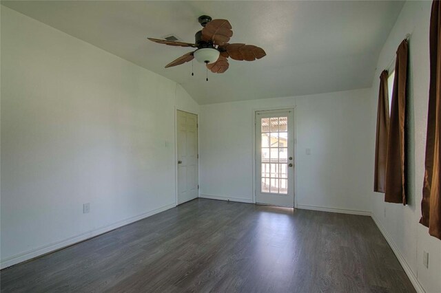 311 August St, Schulenburg, TX 78956 - unfurnished room featuring baseboards, a ceiling fan, vaulted ceiling, and dark wood-style floors