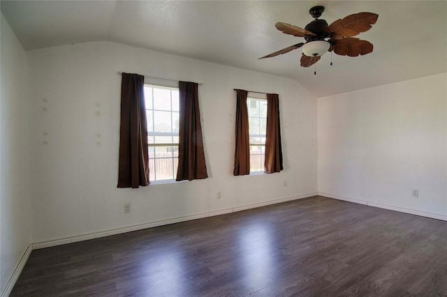 311 August St, Schulenburg, TX 78956 - spare room featuring vaulted ceiling, dark wood-style flooring, and ceiling fan