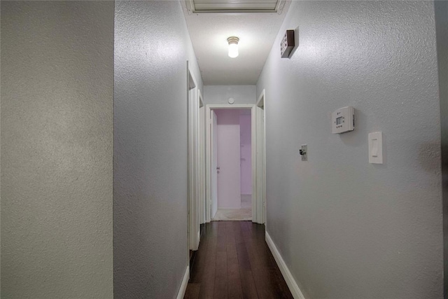311 August St, Schulenburg, TX 78956 - corridor featuring hardwood / wood-style flooring, attic access, and a textured wall