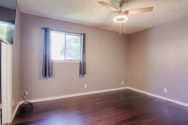 311 August St, Schulenburg, TX 78956 - empty room with dark wood-style flooring, baseboards, a ceiling fan, and a textured ceiling