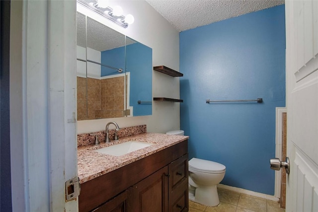 311 August St, Schulenburg, TX 78956 - full bathroom with a textured ceiling, vanity, a shower, and tile patterned flooring