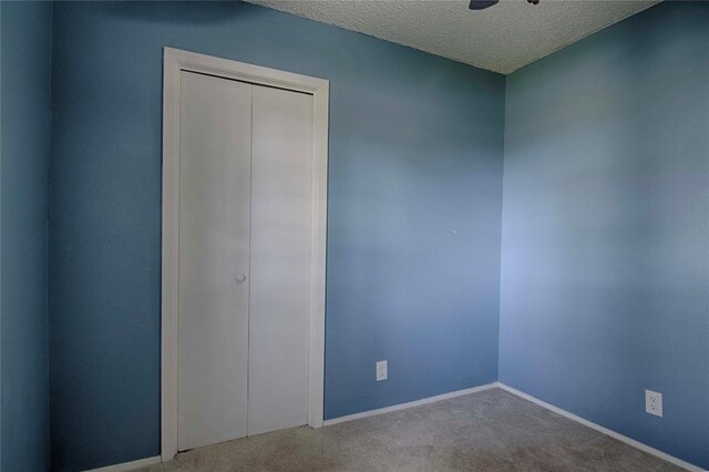 311 August St, Schulenburg, TX 78956 - carpeted empty room with a textured ceiling and baseboards