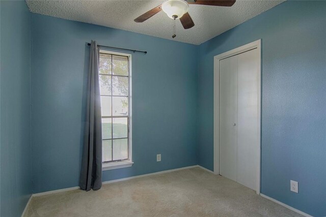 311 August St, Schulenburg, TX 78956 - unfurnished room with carpet flooring, a textured ceiling, baseboards, and ceiling fan