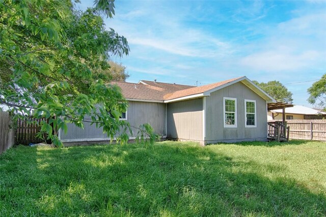 311 August St, Schulenburg, TX 78956 - rear view of house featuring a fenced backyard and a lawn