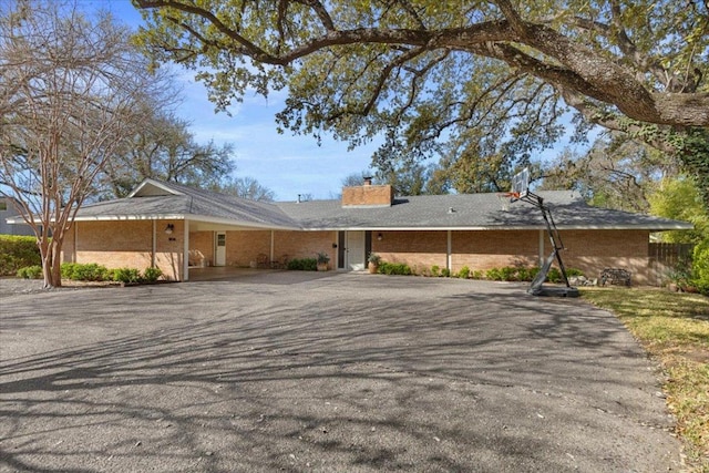 3106 Maywood Ave, Austin, TX 78703 - ranch-style home with a chimney, driveway, and a carport