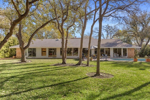 3106 Maywood Ave, Austin, TX 78703 - rear view of property featuring a patio, an outdoor pool, a lawn, and a chimney