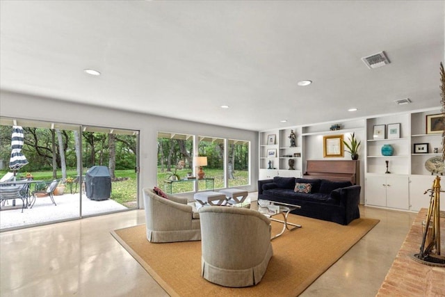 3106 Maywood Ave, Austin, TX 78703 - living room featuring plenty of natural light, finished concrete flooring, built in features, and recessed lighting