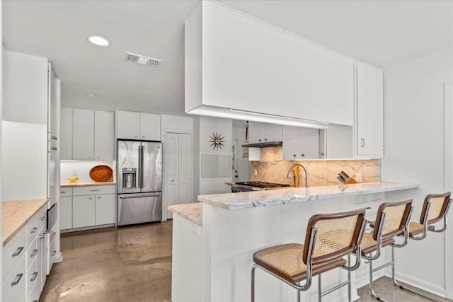 3106 Maywood Ave, Austin, TX 78703 - kitchen with high quality fridge, a peninsula, decorative backsplash, white cabinetry, and concrete flooring