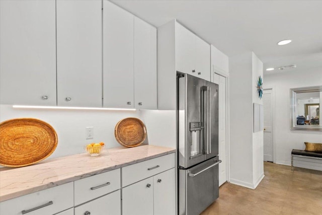 3106 Maywood Ave, Austin, TX 78703 - kitchen with high end fridge, white cabinets, concrete floors, light stone countertops, and recessed lighting