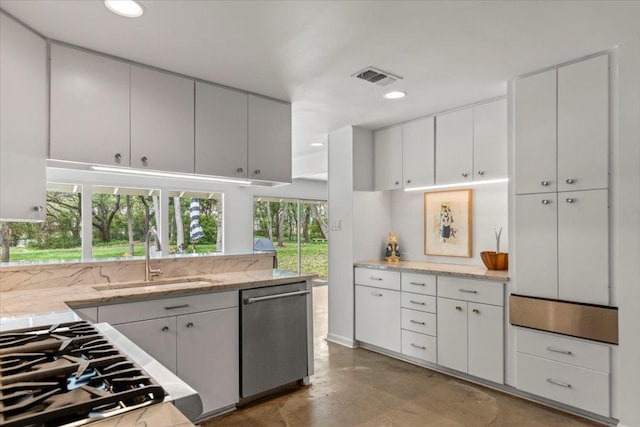 3106 Maywood Ave, Austin, TX 78703 - kitchen featuring stainless steel dishwasher, a sink, finished concrete floors, white cabinets, and gas cooktop