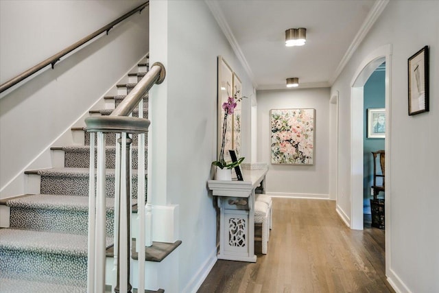1710 Mccall Rd, Austin, TX 78703 - stairs with arched walkways, crown molding, and wood finished floors