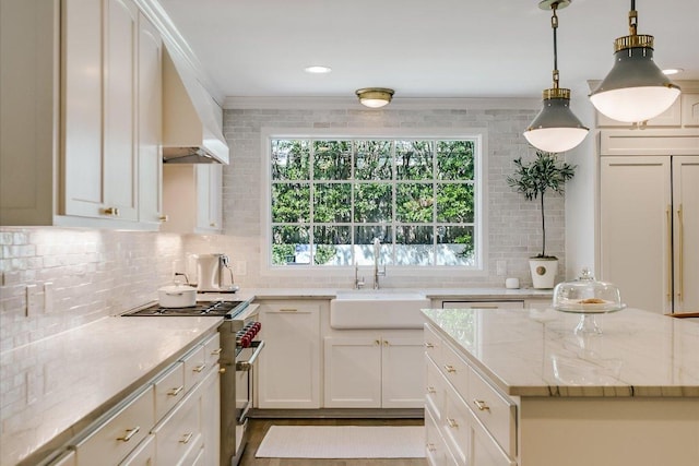 1710 Mccall Rd, Austin, TX 78703 - kitchen featuring range with two ovens, crown molding, decorative backsplash, light stone countertops, and hanging light fixtures
