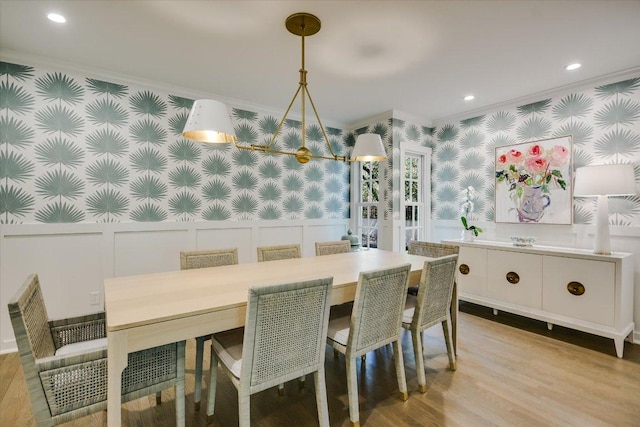 1710 Mccall Rd, Austin, TX 78703 - dining room with crown molding, a decorative wall, wallpapered walls, a wainscoted wall, and light wood-type flooring