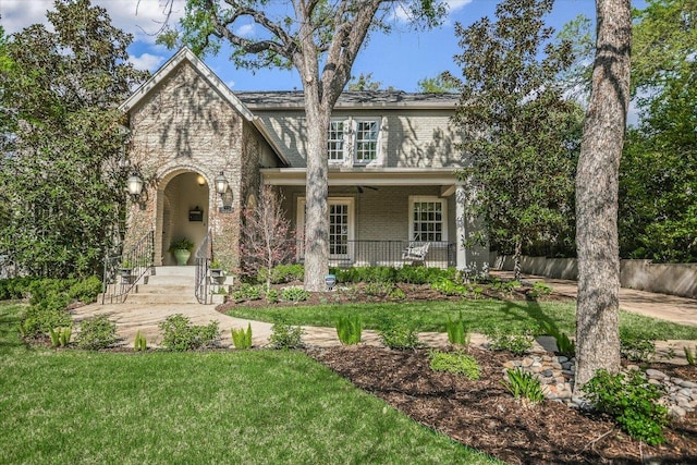 1710 Mccall Rd, Austin, TX 78703 - view of front facade featuring brick siding, a front yard, and covered porch