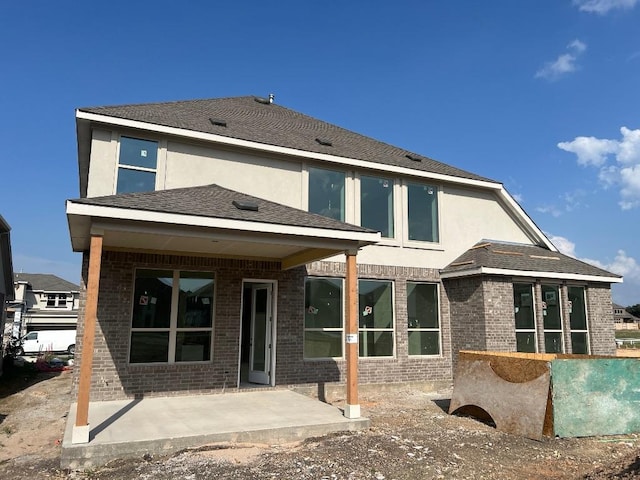 937 Sunny Ridge Dr, Leander, TX 78641 - rear view of house featuring a patio area, brick siding, and stucco siding