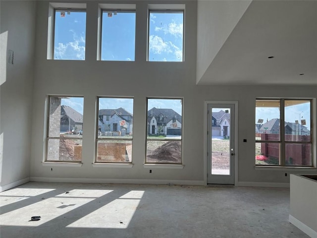 937 Sunny Ridge Dr, Leander, TX 78641 - unfurnished living room with a towering ceiling and baseboards