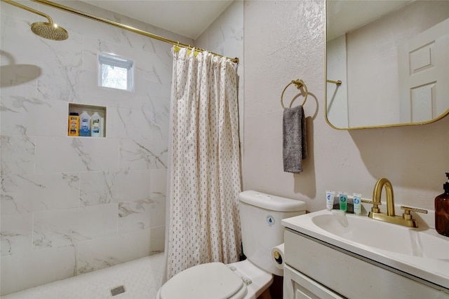 full bath with tiled shower, vanity, and toilet