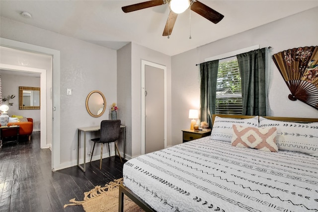 bedroom featuring ceiling fan, baseboards, and dark wood finished floors