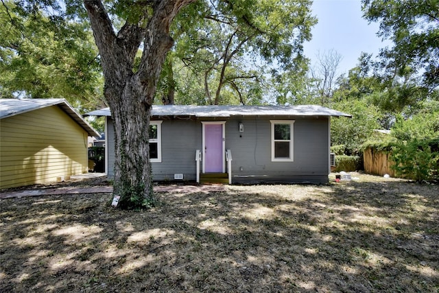 back of house with entry steps and fence