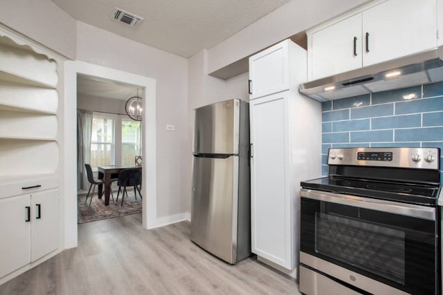 kitchen with white cabinets, visible vents, under cabinet range hood, stainless steel appliances, and decorative backsplash
