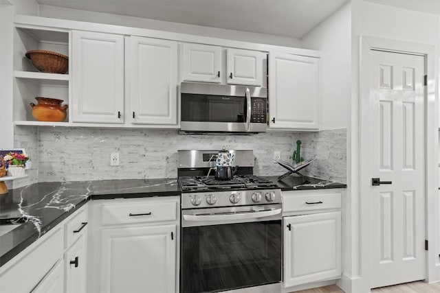 13436 Moscow Trl, Austin, TX 78729 - kitchen featuring stainless steel appliances, white cabinetry, and decorative backsplash