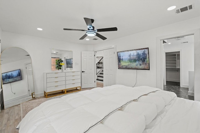 13436 Moscow Trl, Austin, TX 78729 - bedroom with recessed lighting, baseboards, arched walkways, ceiling fan, and a walk in closet