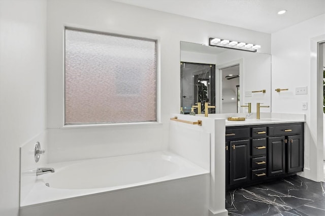 13436 Moscow Trl, Austin, TX 78729 - bathroom with a garden tub, marble look tiles, vanity, and recessed lighting